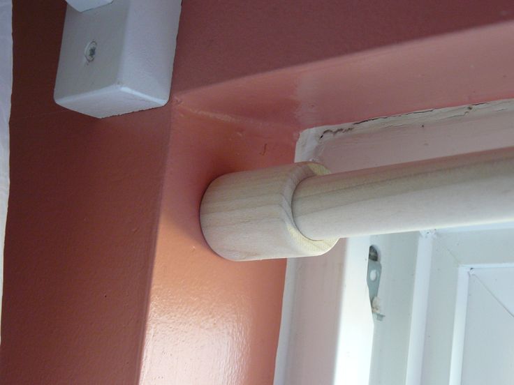 a white door handle on a pink wall