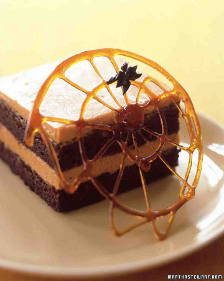 a piece of cake with an orange slice on it sitting on top of a white plate