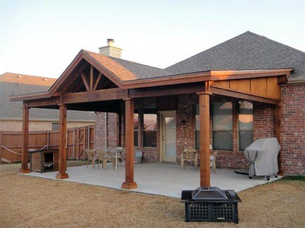 a covered patio with an outdoor grill and bbq