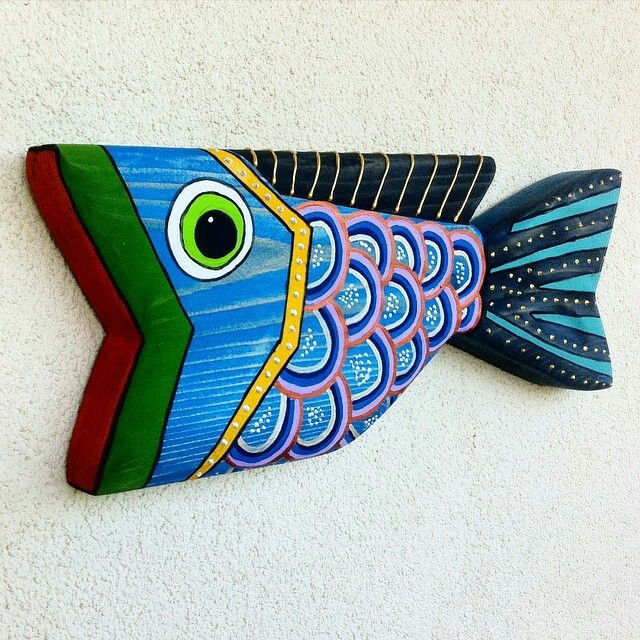 a colorful fish is hanging on the wall