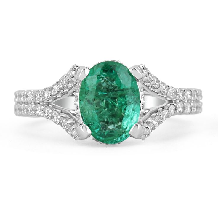 This is an exquisite, Colombian emerald and diamond halo split shank ring. The gorgeous setting lets sit an excellent quality Colombian emerald with beautiful color and very good eye clarity. The emerald is not perfect and small imperfections do exist as it is a natural gemstone. Near colorless diamonds halo around the emerald and down the split shank! This ring is incredibly comfortable to wear and would be an ideal engagement ring! Setting Style: Prong/Pave Setting Material: 14K White Gold Set Dazzling Oval Emerald Ring In Platinum, Oval Emerald Ring With Halo Setting In Platinum, Elegant Oval Platinum Emerald Ring With Halo Setting, Oval Platinum Emerald Ring With Halo Setting, Oval Emerald Ring With Prong Setting In Platinum, Oval Platinum Emerald Ring With Prong Setting, White Gold Emerald Ring With Diamond Accents, Oval Shape, Oval Emerald Ring In White Gold With Diamond Accents, Dazzling Oval Emerald Ring For Formal Occasions