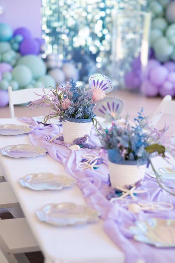 the table is set with purple and blue decorations