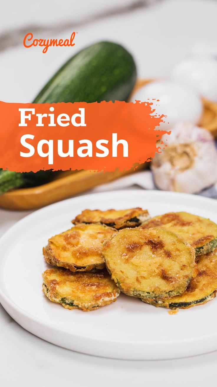 fried squash on a white plate next to some vegetables