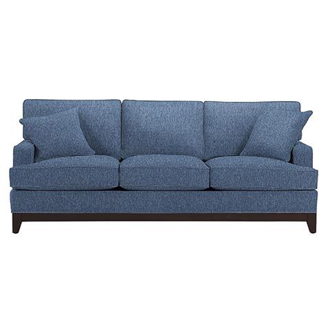 a blue couch sitting on top of a white floor