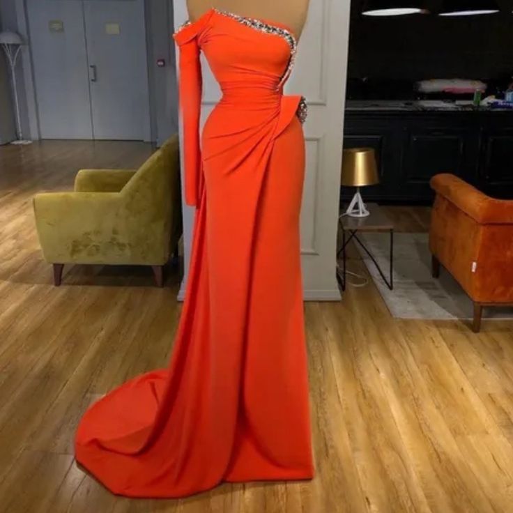 an orange dress is on display in the living room