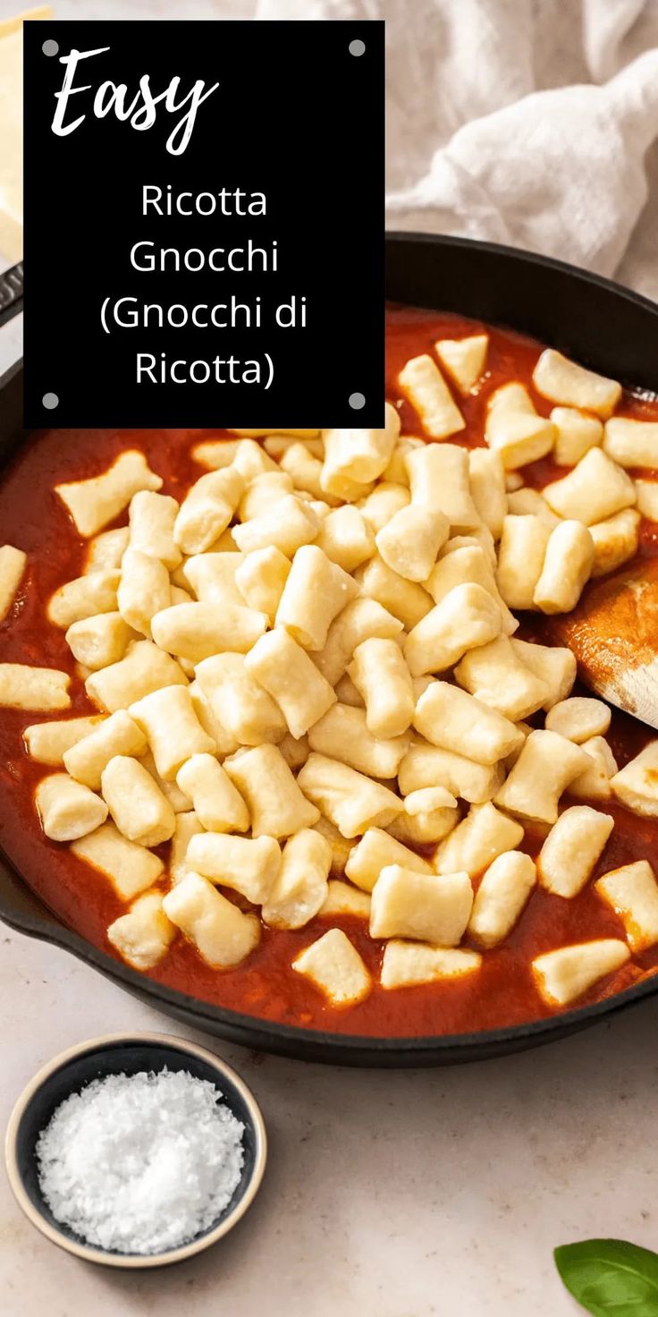 an image of some food in a pan on the table with salt and seasoning