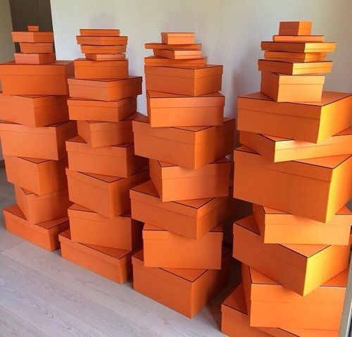 many orange boxes stacked on top of each other