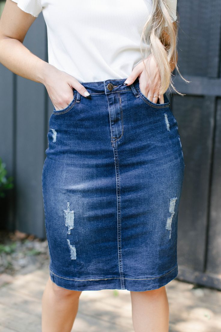 Another exclusive denim skirt is here! Introducing the 'Indie', a perfect blend of classic and trendy with a dark blue wash with fun distressed details! This knee length skirt is made from a quality stretch denim for a modest and flattering fit. The skirt is patched behind the distressing so no need to worry about layering underneath! Guaranteed to go with just about everything from a casual tee to a flowy, feminine blouse. With this denim skirt in your wardrobe, you won't have the problem of no Knee Length Denim Skirt Outfit, Skirt Outfit Denim, Knee Length Jean Skirt, Outfit Denim Skirt, Denim Skirt Knee Length, Knee Length Jean Skirts, Summer Denim Skirt, Wildflower Drawing, Denim Skirts Knee Length