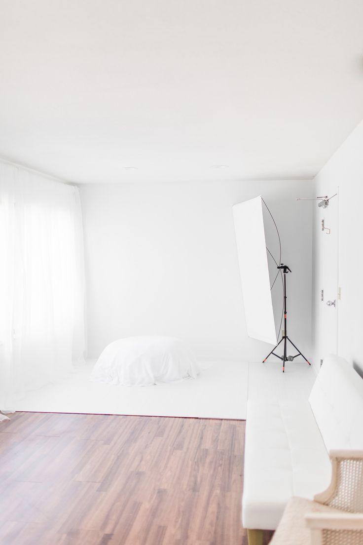 an empty room with white walls and hard wood flooring is seen in this image