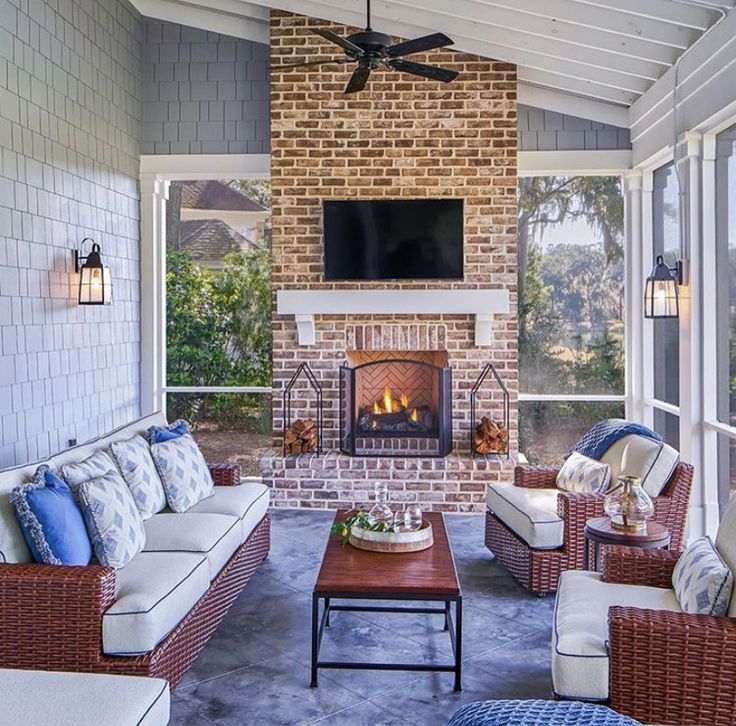 a living room filled with furniture and a flat screen tv mounted on the wall above a fire place