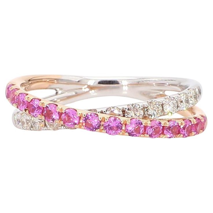 two rings with pink and white stones on each one, set in 18k gold