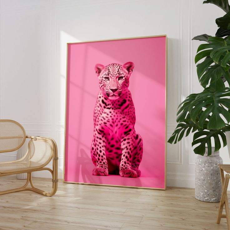 a pink poster with a cheetah sitting on the floor next to a chair