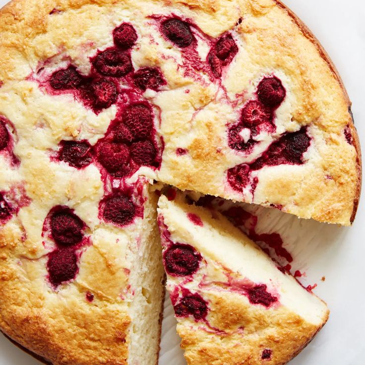 a close up of a cake with berries on it