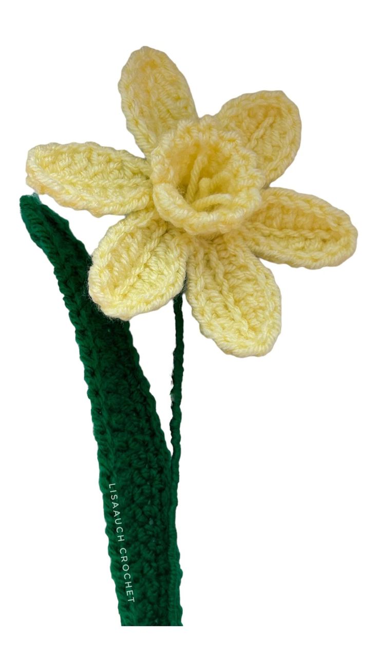 a crocheted yellow flower with green stems