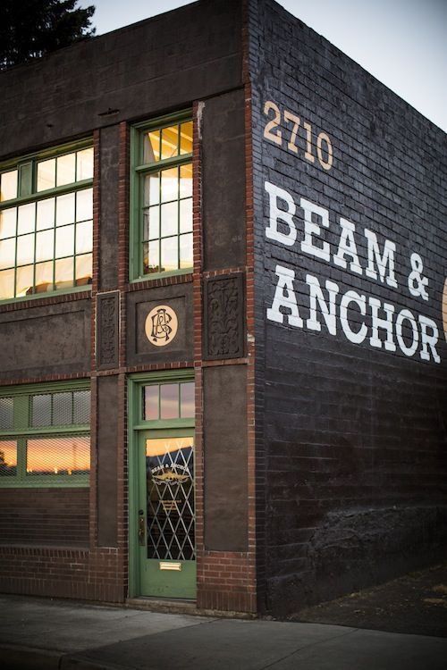 an old brick building with the words beam and anchor painted on it