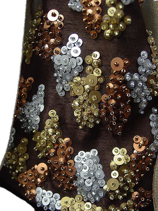 there is a brown and silver sequins on the fabric that has been sewn