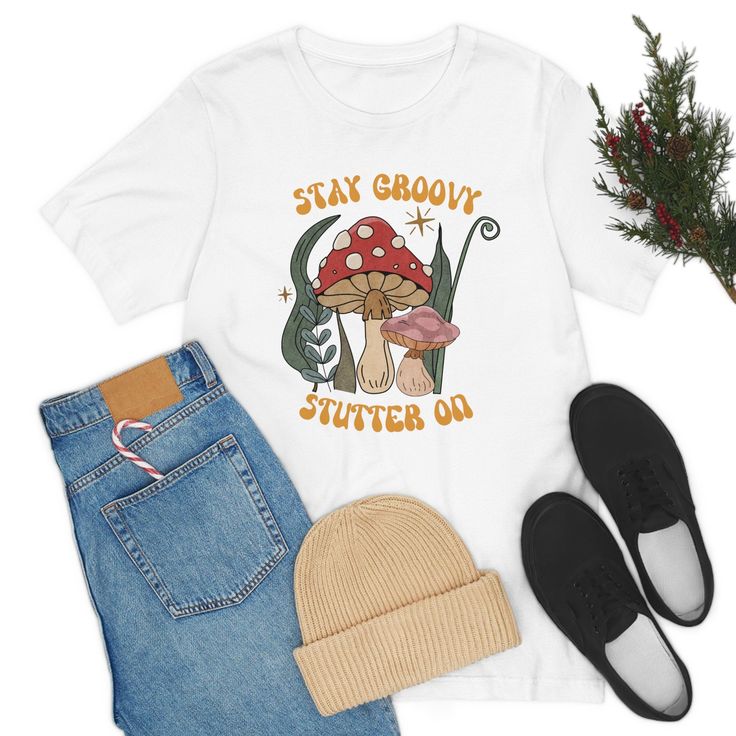 ✨This "Stay Groovy Stutter on" retro 70s unisex t-shirt is an ideal gift for yourself, friends, and relatives who stutter. It’s the perfect way to show you are proud to advocate for people who stutter, as part of the Normalize Stuttering movement. A portion of the proceeds will go towards National Stuttering Association (NSA) support groups - thank you for your support of the Normalize Stuttering movement! 🌟🌟🌟🌟🌟🌟🌟🌟🌟🌟🌟🌟🌟🌟🌟🌟🌟🌟🌟🌟🌟🌟🌟🌟🌟🌟🌟 ✨This classic unisex jersey short s Groovy Short Sleeve T-shirt With Funny Print, Retro Fall T-shirt With Funny Print, Retro Cotton T-shirt With Funny Print, Unisex Retro T-shirt With Custom Print, Groovy T-shirt With Funny Print And Short Sleeves, Groovy Cotton T-shirt With Letter Print, Retro Funny Print Fall T-shirt, Vintage Cotton T-shirt With Mushroom Print, Casual Short Sleeve T-shirt With Mushroom Print