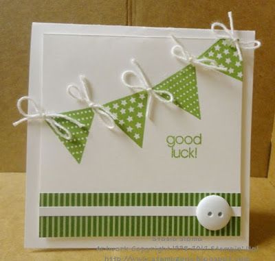 a close up of a greeting card with paper buntings on it and a button