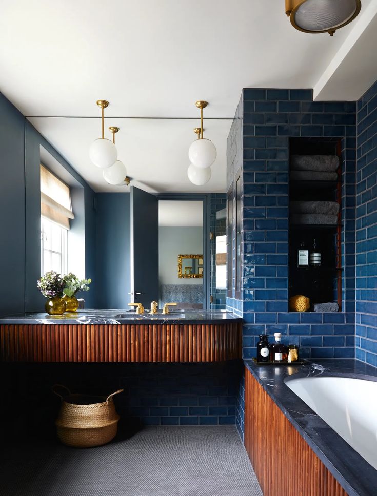 a large bathroom with blue brick walls and wood trimmings on the countertop