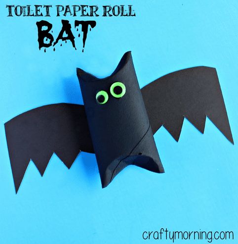 toilet paper roll bat craft for halloween with eyes and mouth on blue background, text reads toilet paper roll bat