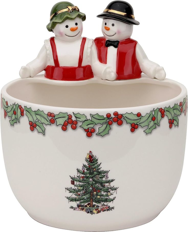 two snowmen sitting on top of a bowl