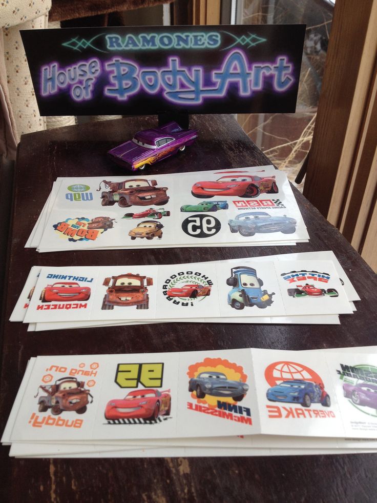 some stickers are sitting on a table next to a sign that says, cars and trucks