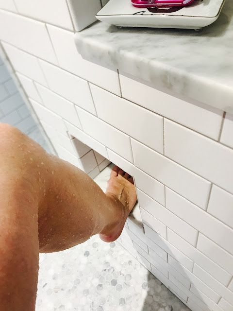 a person standing in front of a bathroom sink