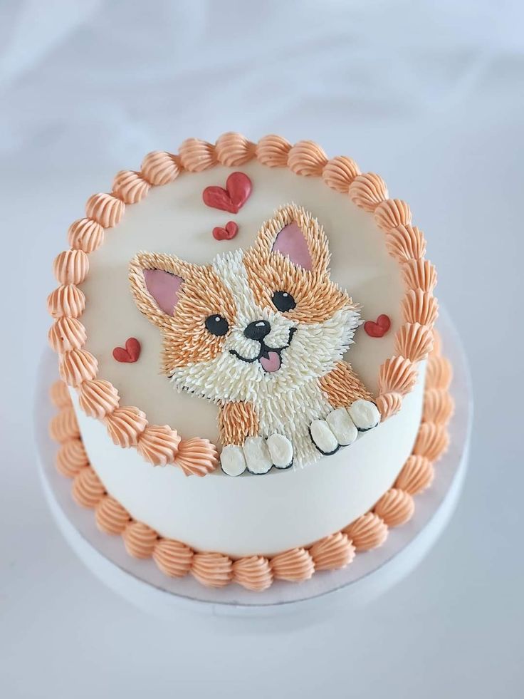 a small cake decorated with an image of a dog on it's face and hearts around the edges