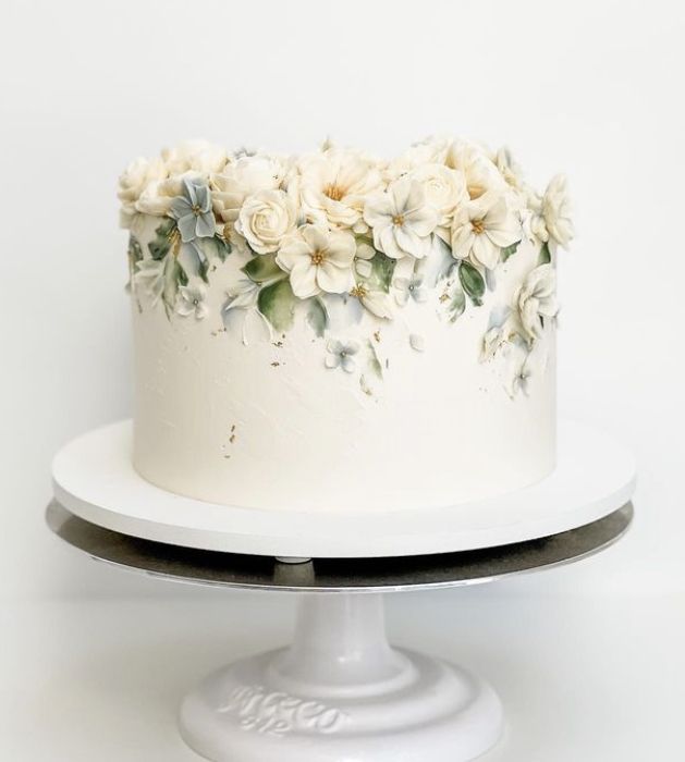 there is a white cake with flowers on it