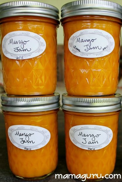 four jars of mango jam sitting on a counter