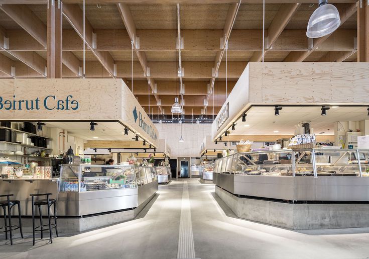 the interior of a deli restaurant with counter tops and stools on either side