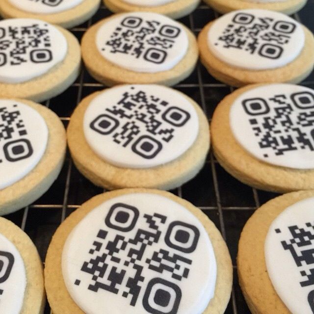 some cookies with qr code designs on them