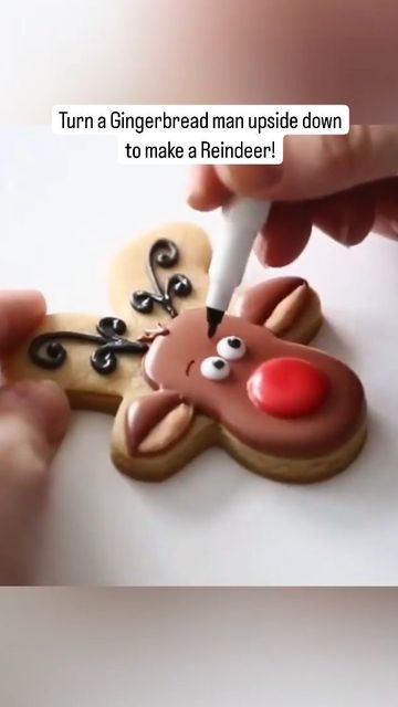 someone is decorating a gingerbread man upside down to make a reindeer ornament