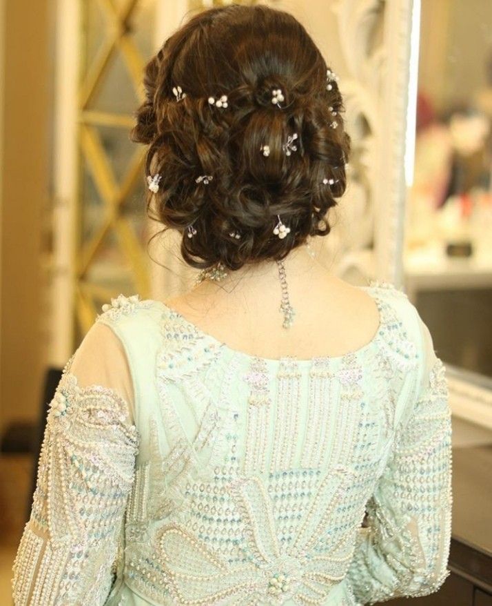 the back of a woman's head wearing a dress with beading on it