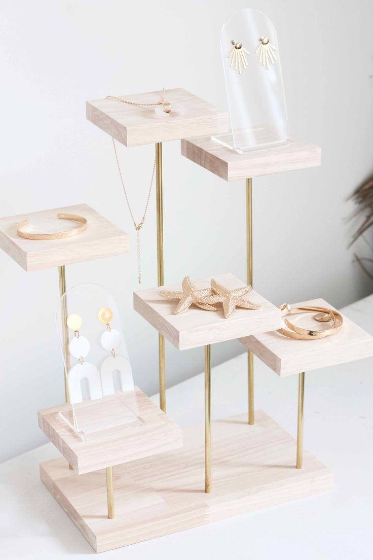 three wooden shelves with jewelry on them