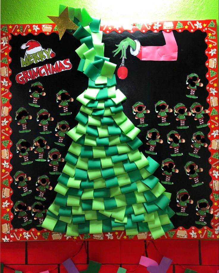 a christmas tree made out of strips of green paper on top of a bulletin board