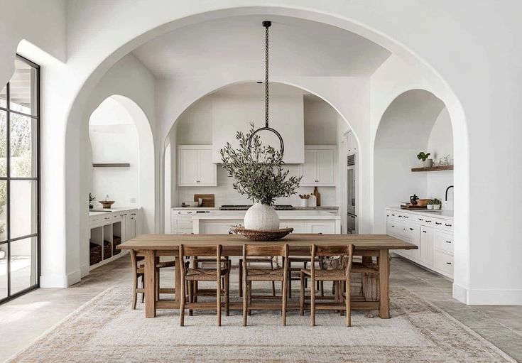 a large dining room table surrounded by arches