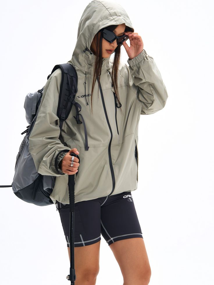 Crafted for hiking and mountain exploration, the Blade Tech® Rain Jacket in matcha green combines functionality with advanced Teflon® coated nylon fabric for superior water, oil, and stain resistance. The multi-directional adjustable hood and hem ensure a perfect fit. Concealed YKK zip pockets, including a chest pocket for quick access and larger storage capacity. Logo prints on the front and back, finished with signature GRKC garment labels. Teflon® Coated Fabric Water, Oil, and Stain-Resistant Multi-Directional Adjustable Hood Concealed YKK Zip Pockets Slightly Oversized Fit Part of the GRKC® Utility Performance Series. Model Eric is 177cm / 5'10" tall and wearing size L Model Kori is 168cm / 5'6" tall and wearing size L *Please allow up to 2 weeks for processing and shipment. Nylon Windbreaker With Drawstring Hood For Hiking, Functional Green Outerwear For Travel, Technical Outdoor Windbreaker With Drawstring Hood, Waterproof Nylon Hooded Jacket For Outdoor, Waterproof Nylon Hooded Jacket For Outdoor Activities, Hooded Techwear Outerwear For Adventure, Hooded Nylon Raincoat For Hiking, Practical Nylon Hooded Windbreaker, Khaki Weatherproof Techwear Windbreaker