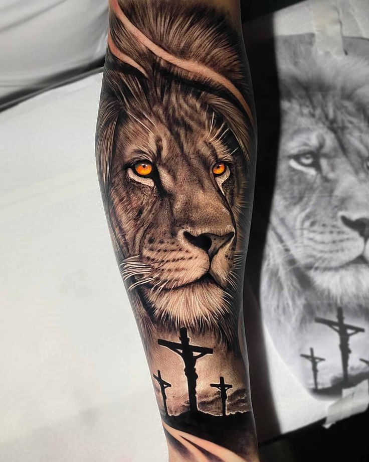 a man with a lion and cross tattoo on his arm