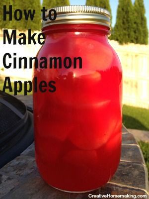 a jar filled with red liquid sitting on top of a wooden table