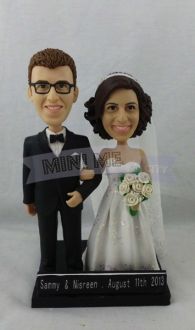 a wedding cake topper with a bride and groom