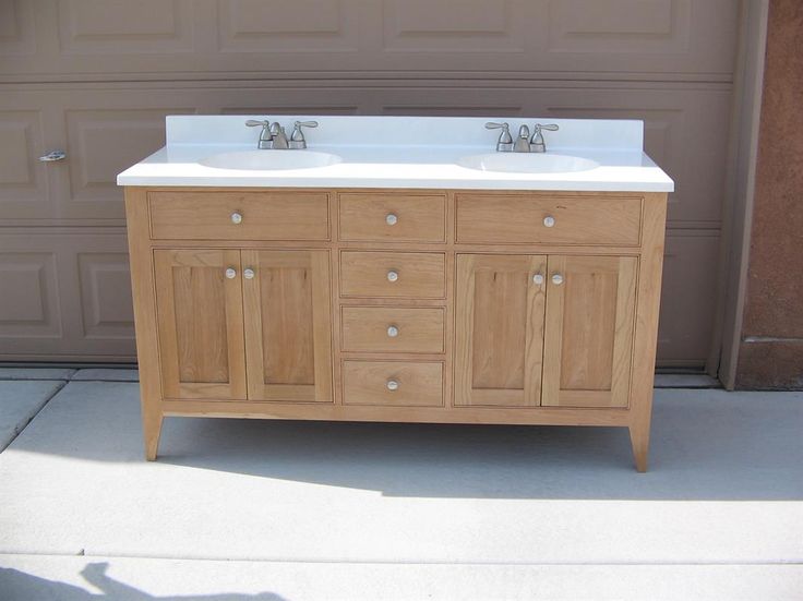 a double sink vanity in front of a garage door