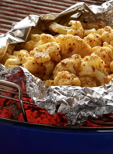 some kind of food that is on top of a bbq grill with tin foil