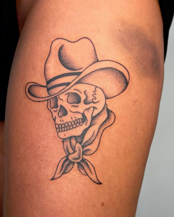 a skull wearing a cowboy hat with a bow tie around it's neck is shown