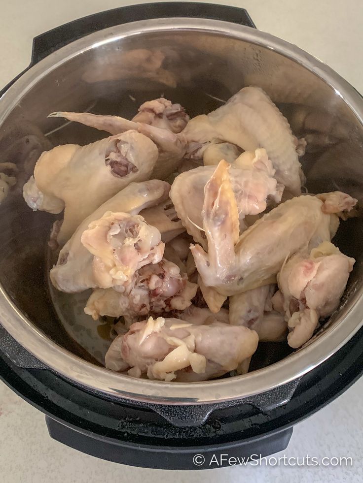 raw chicken in an electric pressure cooker ready to be cooked for the next meal