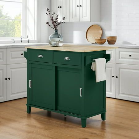 a green kitchen island in a white kitchen with wooden floors and cabinets on both sides