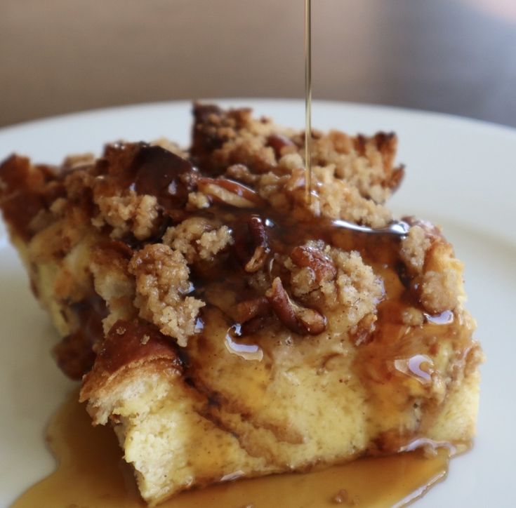 a piece of cake with caramel sauce drizzled over it on a white plate