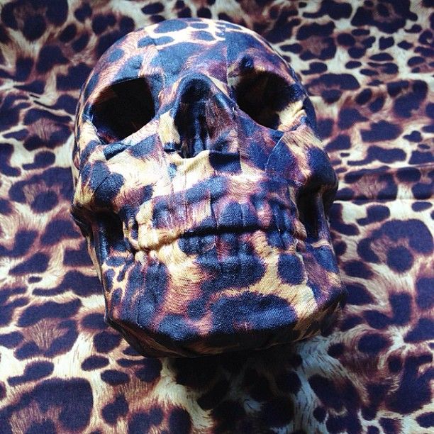 an animal print fabric with a skull on it's face and the bottom part of its head