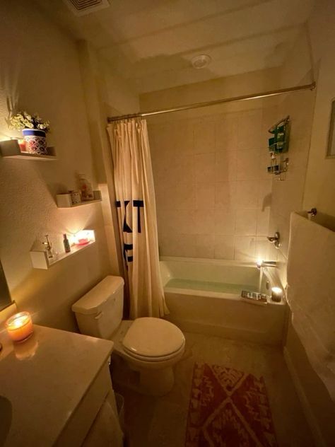 a bath room with a toilet a tub and a sink