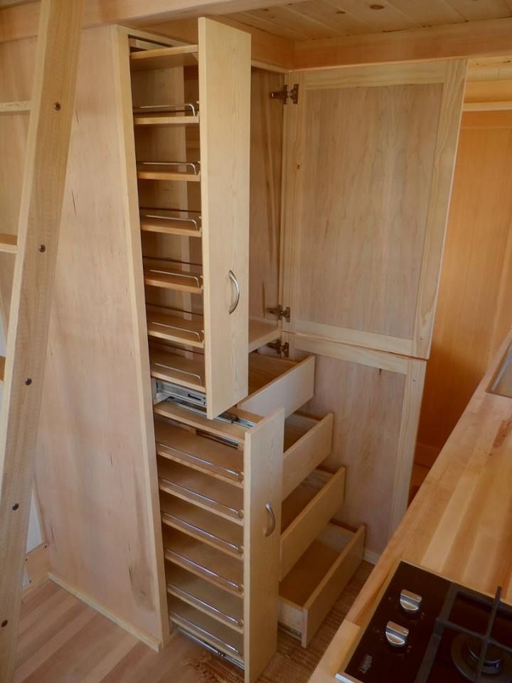 a kitchen with wooden cabinets and drawers in it